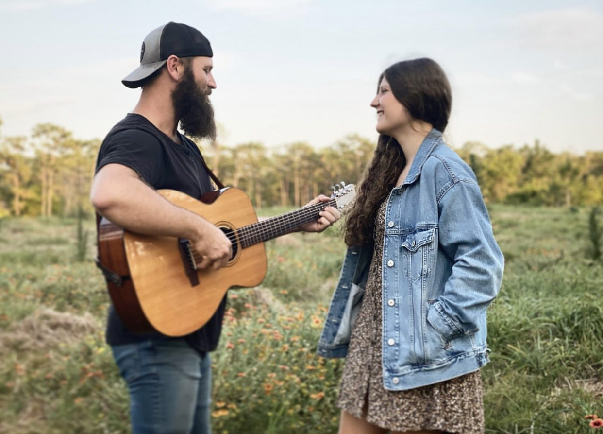 Drew and Ava Miller in a wildflower field
